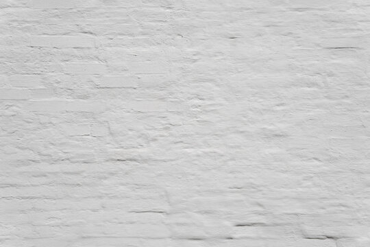 Light gray plastered brick wall texture as a clean minimalist background. Aged whitewashed brickwork surface for contemporary interior design or backdrop mockup.