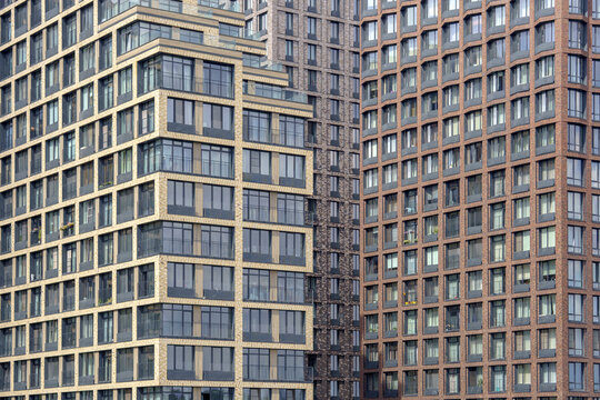 Terraced residential skyscraper facades forming a dense geometric angle. Multi-level apartment buildings structure for modern urban housing backdrop.
