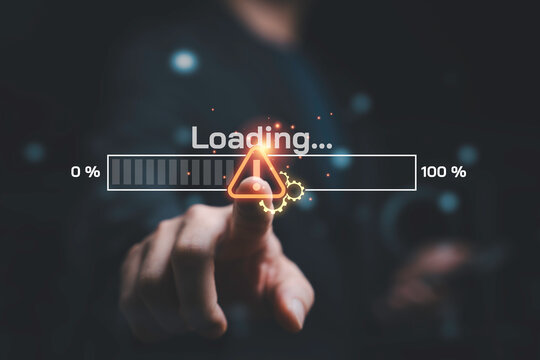 Hand touching warning icon on loading progress bar for symbolizing system error, software update, installation delay, digital technology, processing, troubleshooting and technical problem concept.