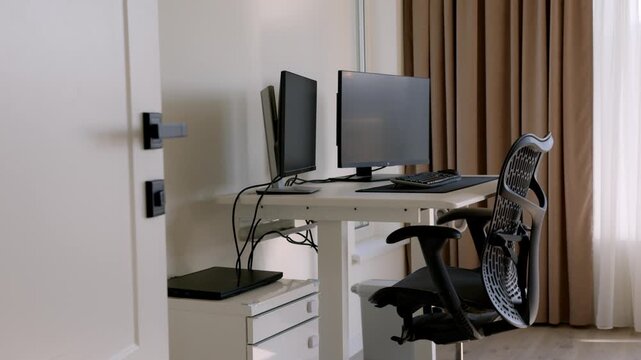 Modern home office with computer desk and ergonomic chair in country house