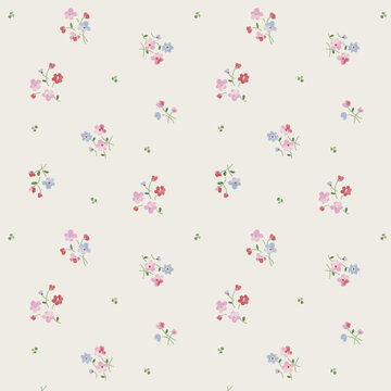Delicate floral pattern with pink and blue blossoms on a cream background
