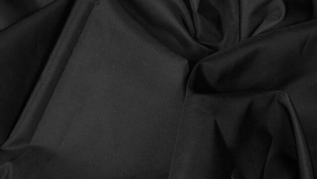 black textile canvas with complex draped folds