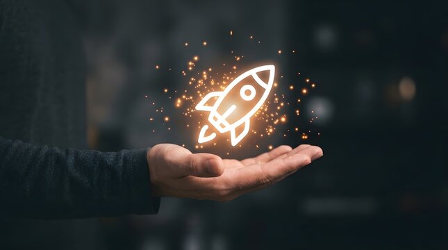 Hand holding rocket ship icon with glowing sparks