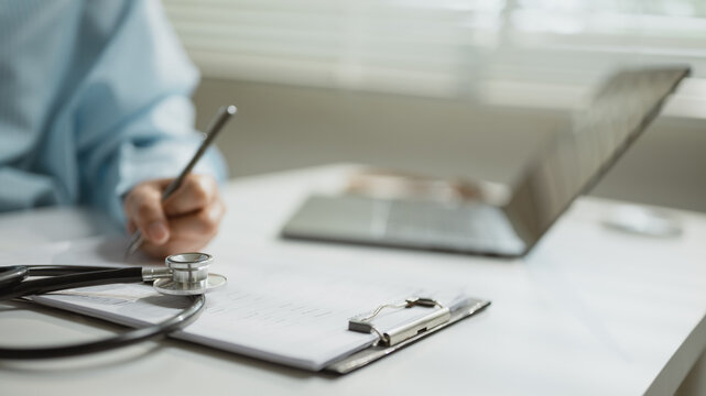 medical insurance paperwork with healthcare costs; medical forms and a stethoscope on a clean desk. medical guides buyer choices, insurance frames the scene, and paperwork adds useful meaning.