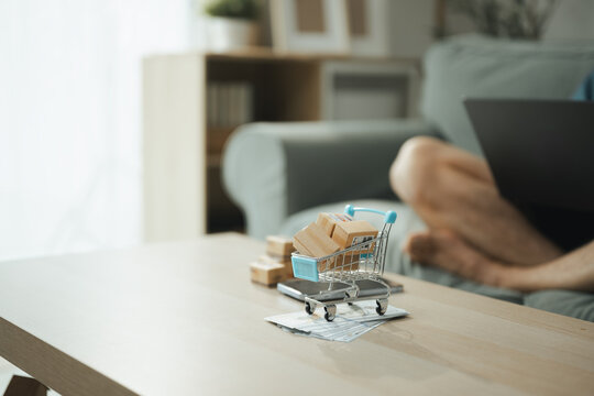 online shopping cart with delivery ecommerce; a shopping cart and parcel boxes prepared for digital retail. online guides buyer choices, shopping frames the scene, and cart adds useful meaning.
