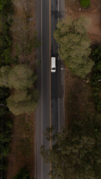 Aerial video of a rural road near a mountain with morning mist in Thailand.	