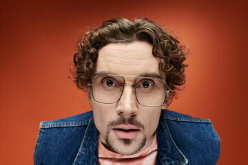 Handsome man showcases fashion and emotion against a vibrant backdrop © LIGHTFIELD STUDIOS