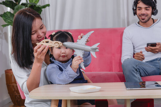 Happy family spending quality time together at home with parents' children enjoying fun and relaxed moment around a table.