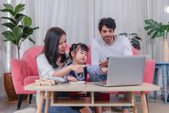 Happy family spending quality time together at home with parents' children enjoying fun and relaxed moment around a table.