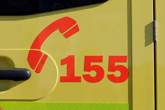 Ambulance emergency vehicle in the Czech Republic and Czechia. Detail of yellow car with bright reflective colors and 155 telephone number. 