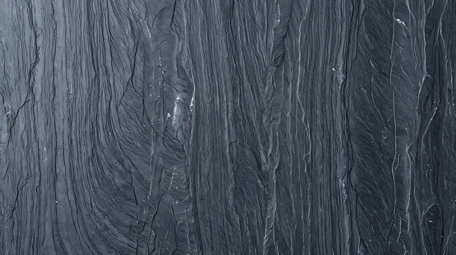 Close-up of textured dark gray slate stone surface with natural striations and rough finish emphasizing organic mineral patterns