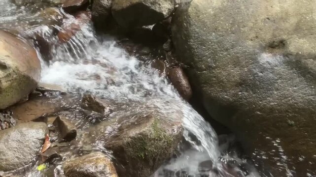Water flowing over rocks and the natural sound of trickling water