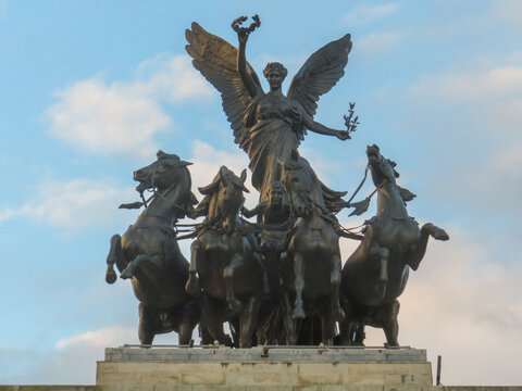 View of the bronze Quadriga statue featuring the winged figure of Victory riding a chariot drawn by four horses atop the Wellington Arch in London, England, United Kingdom.