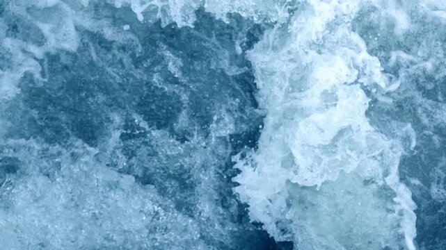 Flowing river water merges with ocean waves in a beautiful natural scene.