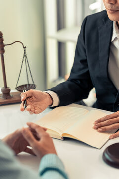 Lawyer and Client Signing Legal Contract Agreement Document in Law Office
