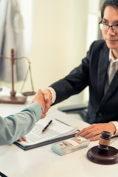Lawyer Shaking Hands with Client After Signing Legal Contract Agreement