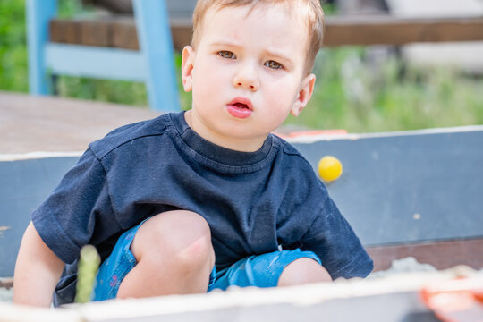 Little boy exploring and learning through everyday outdoor activities.