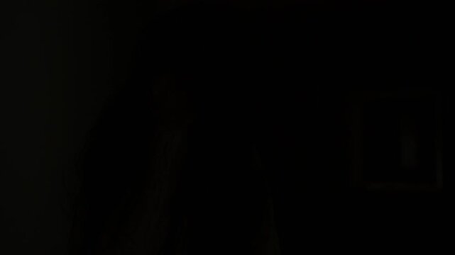 Ghostly woman in white stands in a dark abandoned corridor. Concept of horror, fear, supernatural mystery, haunted place, nightmare, paranormal activity, and scary atmosphere.