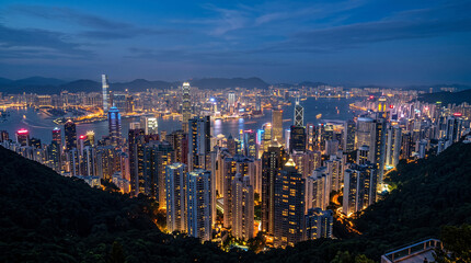 Fototapeta premium Stunning aerial view of the Hong Kong city skyline and Victoria Harbour at night from Victoria Peak 