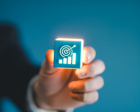 Hand holding business target growth cube
