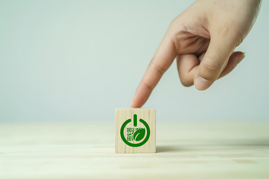 Hand touching wooden block with icon