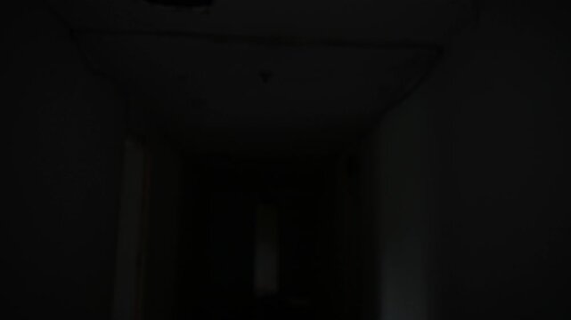 Ghostly woman in white stands in a dark abandoned corridor. Concept of horror, fear, supernatural mystery, haunted place, nightmare, paranormal activity, and scary atmosphere.