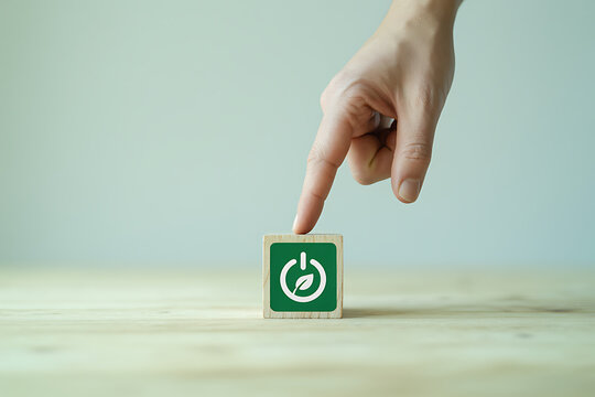 Hand pointing at green wooden cube block