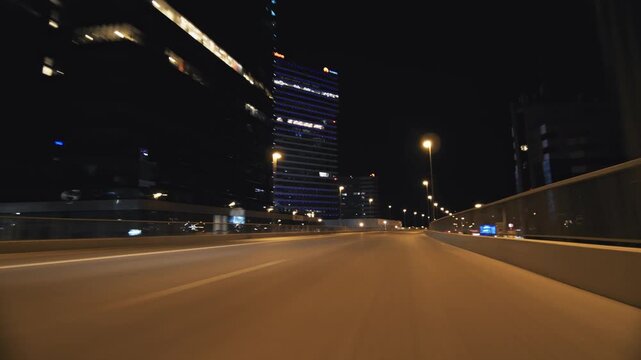 Night driving cityscape with motion blur on highway