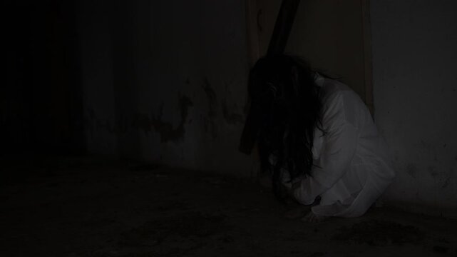 Ghostly woman in white stands in a dark abandoned corridor. Concept of horror, fear, supernatural mystery, haunted place, nightmare, paranormal activity, and scary atmosphere.