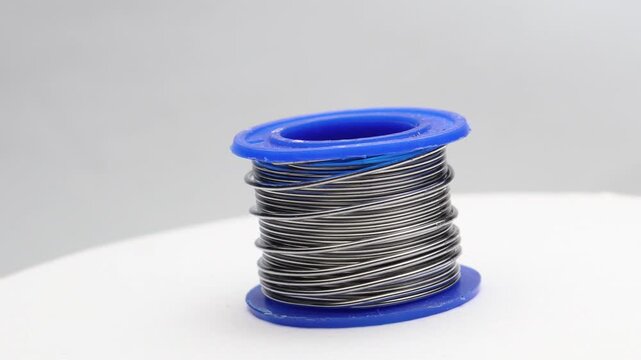 Solder wire with details of the coils on a rotating display. Soldering coils used to join electronic components to printed circuit boards
