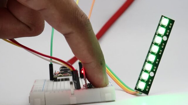 Touch sensor activates a straight RGB LED strip causing colors to fill upward from bottom to top in this simple breadboard electronics project