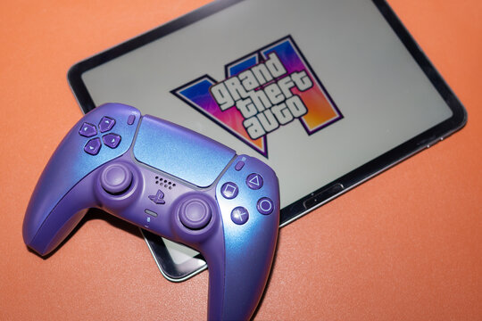 YEREVAN, ARMENIA - 08.11.2026: Sony PlayStation 5 DualSense controller next to a tablet displaying the official Grand Theft Auto VI GTA 6 artwork and logo
