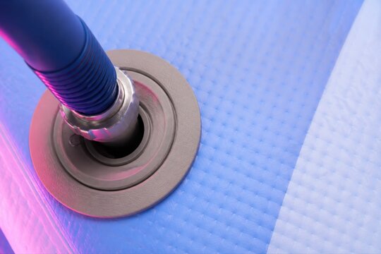 Hoover cleaning blue carpet with close up nozzle