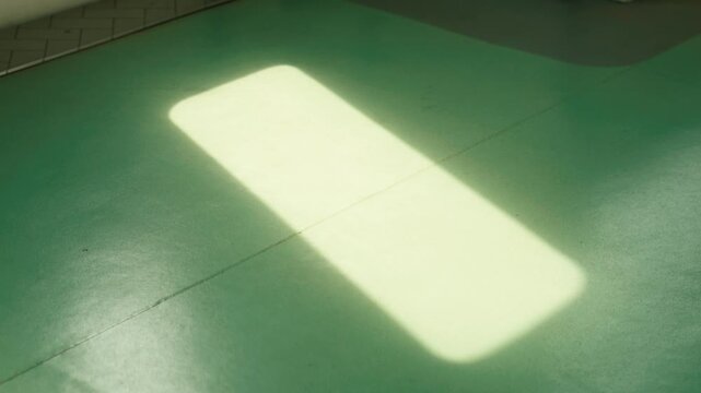Soft Light Patch on Green Floor
