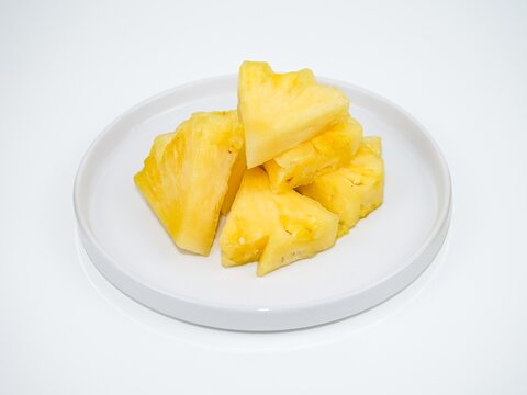 Fresh pineapple slices with half whole pineapple isolated on white background