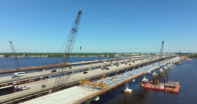 Men at work at construction of new highway bridge lanes in Ellenton, Florida. Expanding infrastructure for cars travel daily across the Trooper J.D. Young Memorial Bridge crossing the Manatee River.