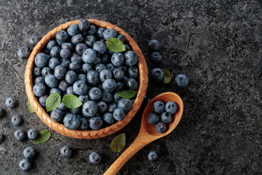 Blueberries with their leaves in wicker bowl.