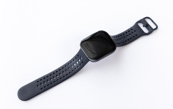 Closeup of a Modern Black Smartwatch with a Perforated Band on White