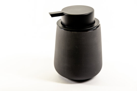 Modern matte black soap dispenser pump bottle on white background