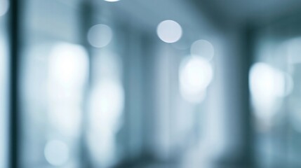 Fototapeta premium Abstract blurred background featuring soft blue and white bokeh lights in a modern architectural space