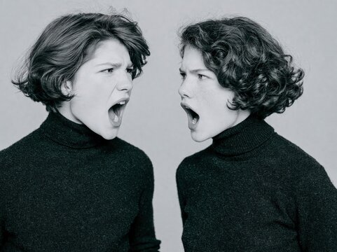 Two angry young people shouting at each other.