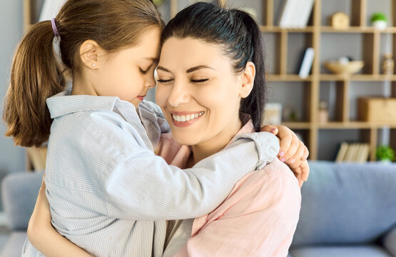 Mother daughter hug shows love and bonding. Warm light highlights affection and happiness as they embrace at home, capturing trust, comfort, and connection. Clear family love concept together.