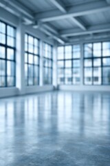 Fototapeta premium Blurry view of empty industrial loft space with large windows and polished concrete floor