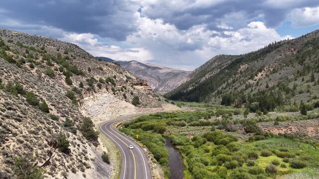 Aerial of Wolf Creek Highway in Duchesne County Utah along Duchesne River in summer along high desert mountains