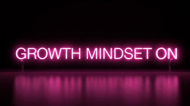 Pink neon sign with growth mindset on text glowing in the dark for motivational business concept.