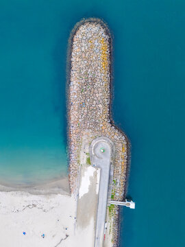 Aveiro Stone breakwater extending into turquoise ocean water. Portugal