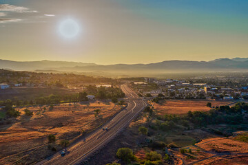 Fototapeta premium Aerial view of a road winding through Pleasant Valley near Washoe Lake along Highway 395 near Reno and Carson City Nevada at Sunrise during summertime.