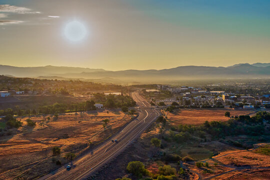 Aerial view of a road winding through Pleasant Valley near Washoe Lake along Highway 395 near Reno and Carson City Nevada at Sunrise during summertime.