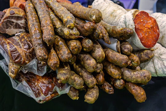Homemade pork sausages pile on market stall outdoor