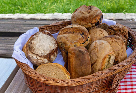 Fresh organic baked homemade raw bread pile inside rattan basket